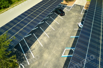 Aerial view of solar panels installed as shade roof over parking lot for parked cars
